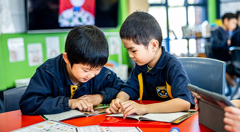 Students reading books in the classroom at St Mary's Primary School Rydalmere